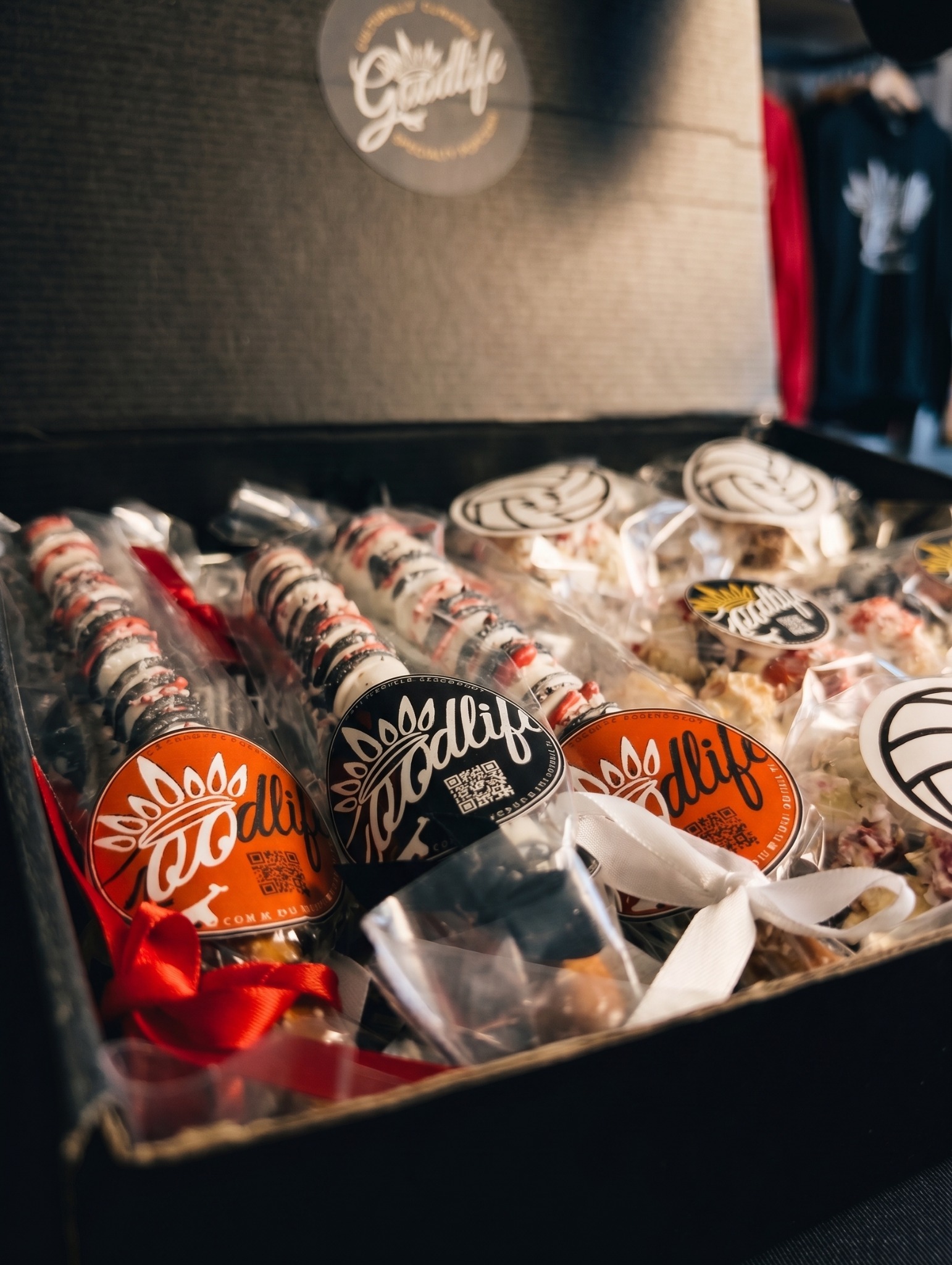 Goodlife Treats presentation with decorated pretzel rods and individually packaged popcorn balls
